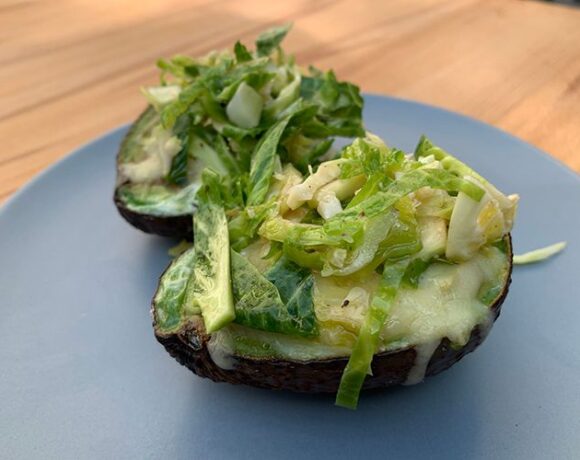 Avocado baked eggs with Brussel sprout salad